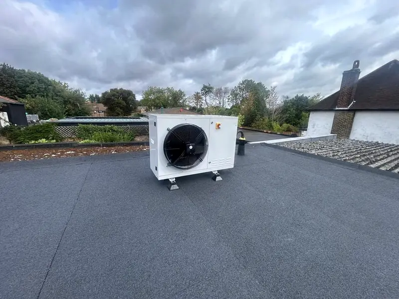 New refrigeration condensing unit on anti-vibration feet on a flat roof