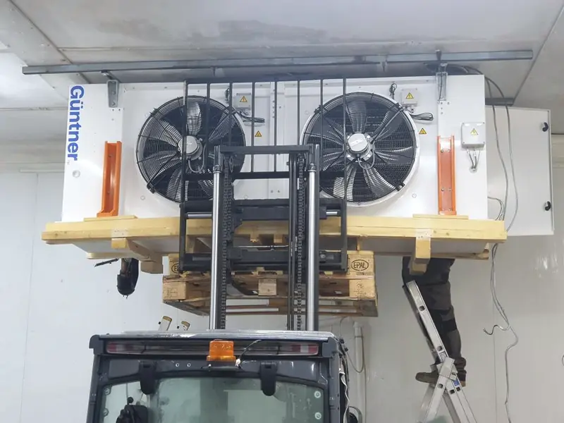 Large Güntner industrial evaporator being lifted into place in a cold store