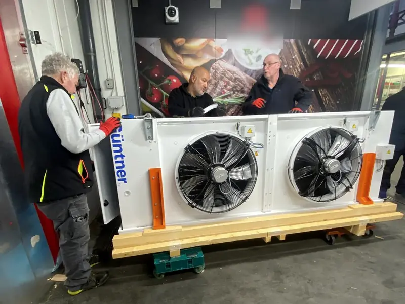 Three North engineers preparing a new Güntner evaporator for installation